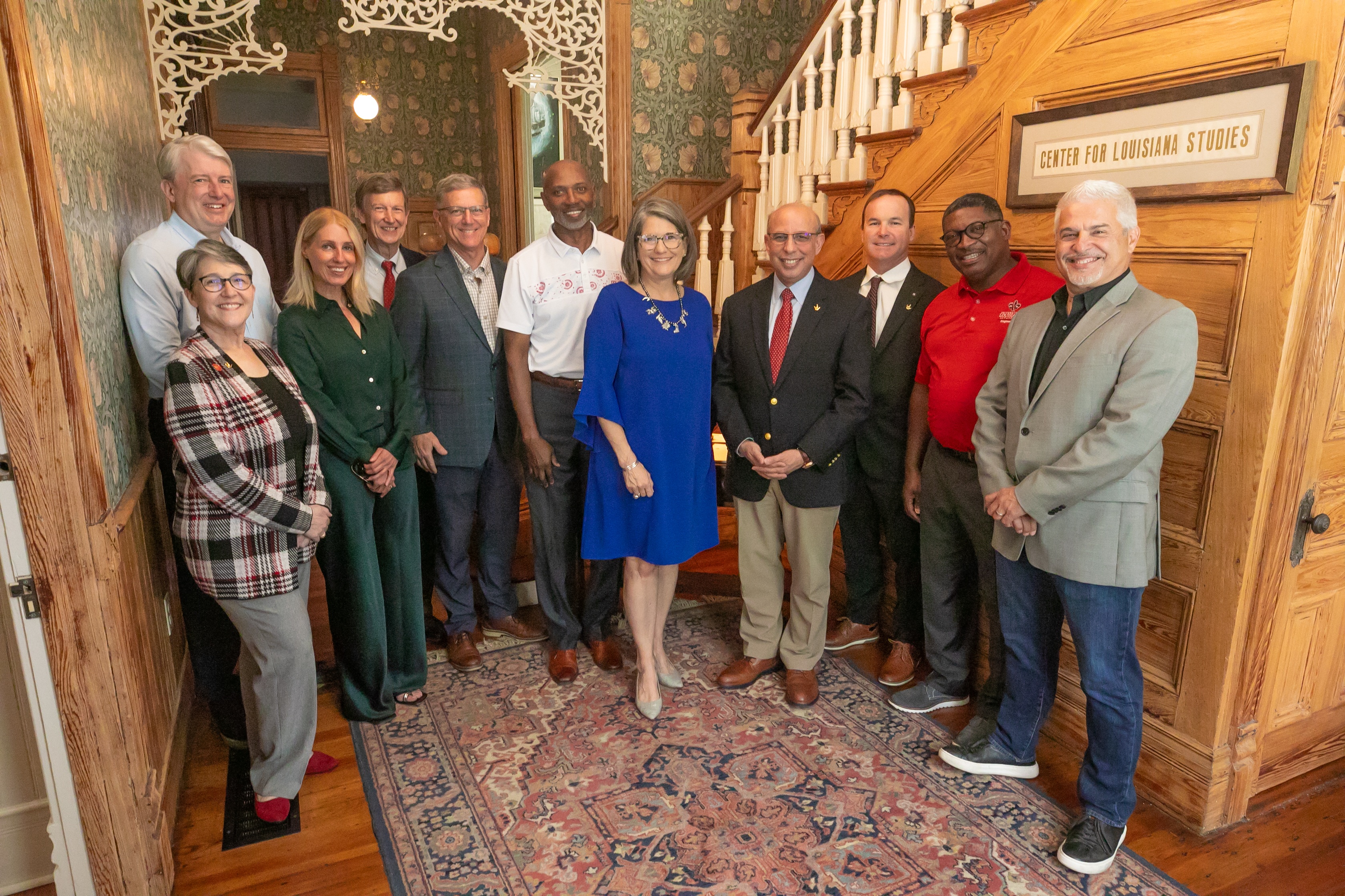 Members of the Dean’s Advisory Council standing in the foyer of the Roy House.