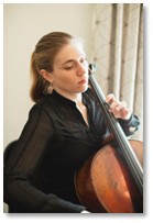 Molly Goforth sitting down playing her cello.