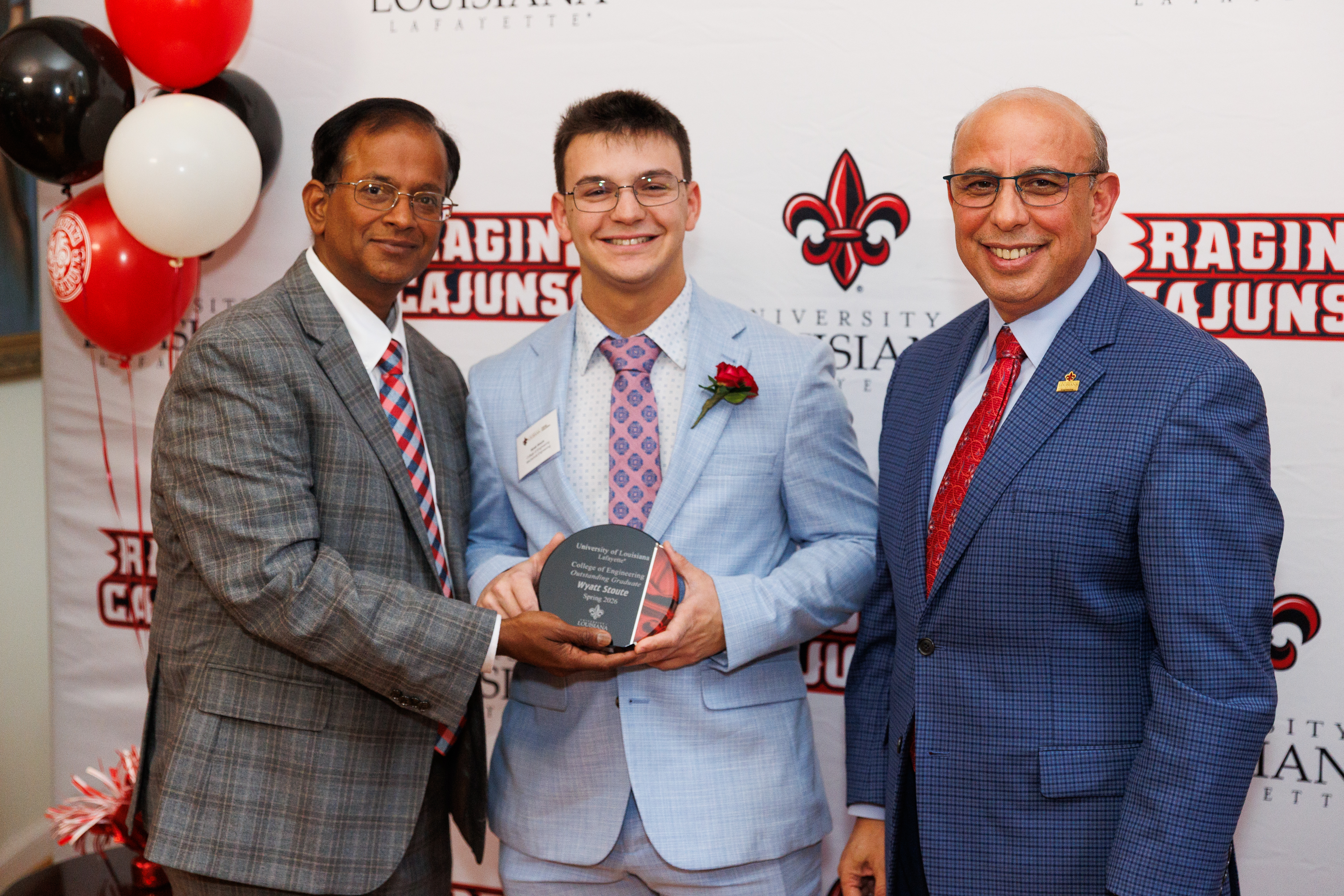 Picture of President Kolluru, Wyatt Stoute, and Dean Ahmed Khattab presenting the Outstanding Student Award in the College of Engineering.